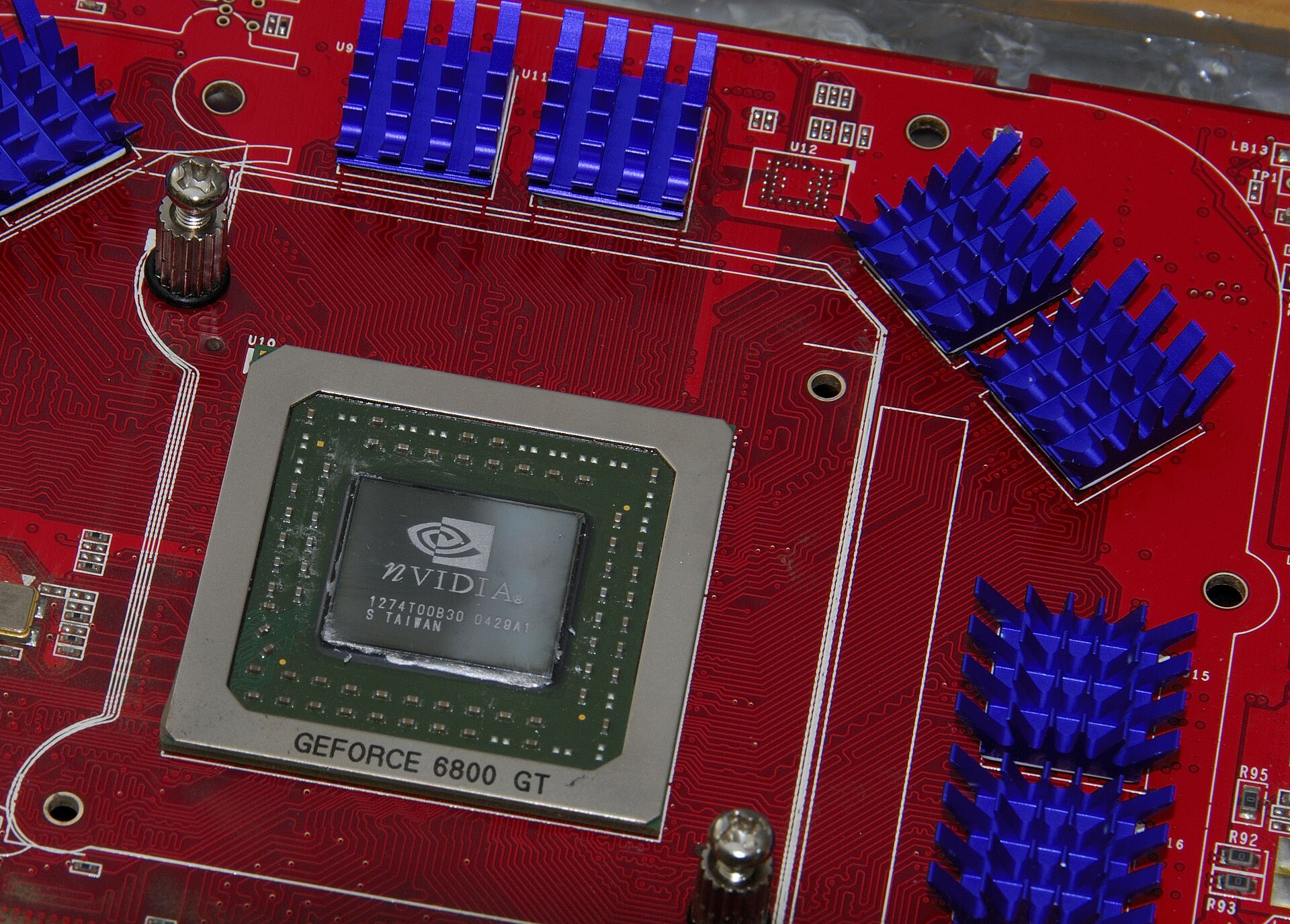 GPU card on a server motherboard with data center rows in the background